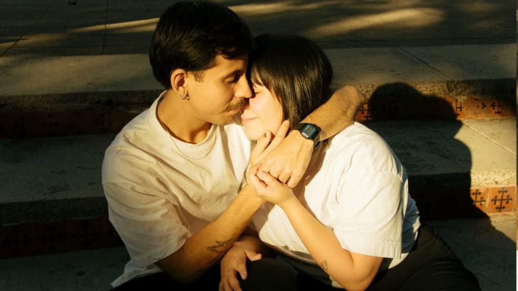 A couple is embracing affectionately and sharing a moment.