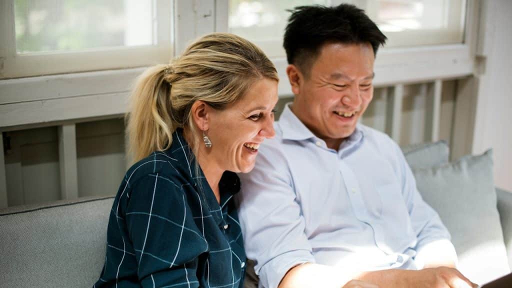 A man and a woman working together on a laptop.