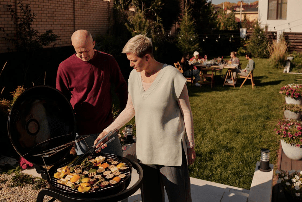 A couple grilling outside