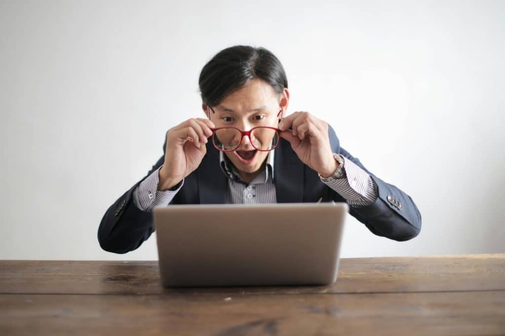 A man looking at the screen