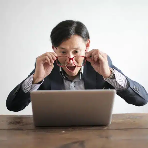 A man looking at the screen