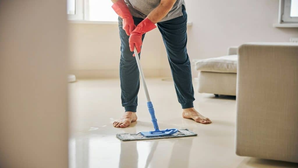 A man cleaning the living room