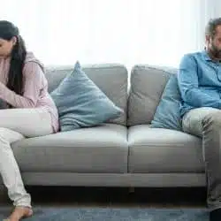A couple ignoring each other at home.