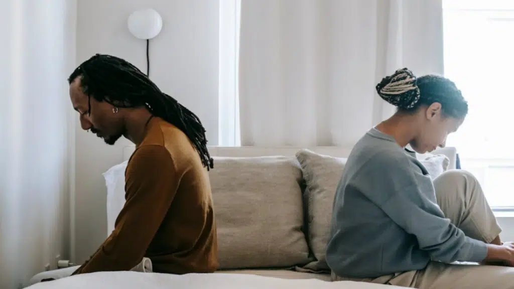 A couple looking sad in bed
