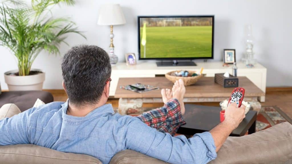 A man watching sport on TV.
