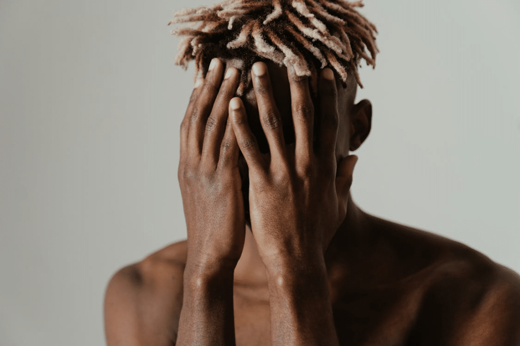 A man covering his face