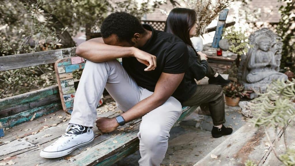 A couple looking sad outdoors