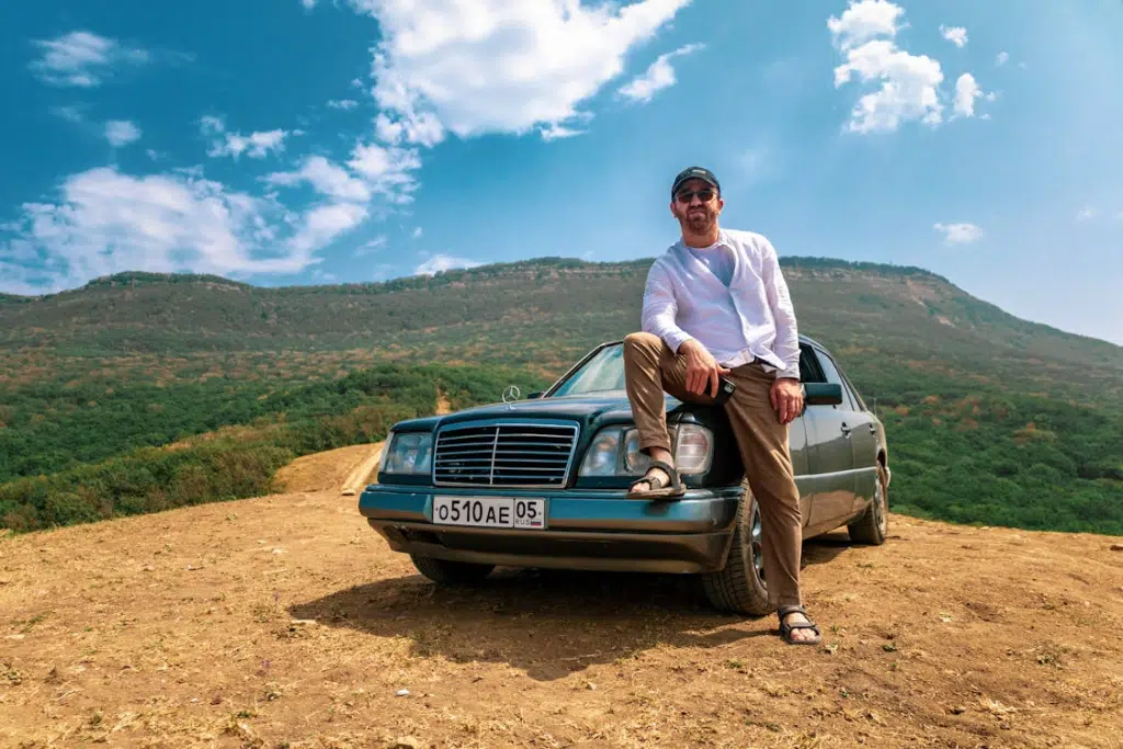 A man standing beside a car