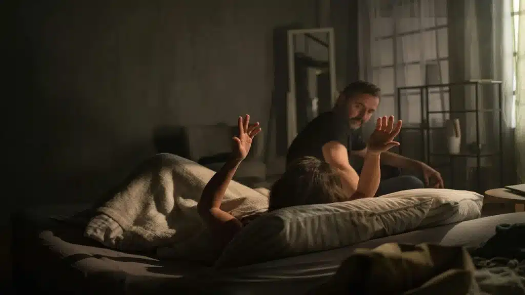 A couple arguing in bed