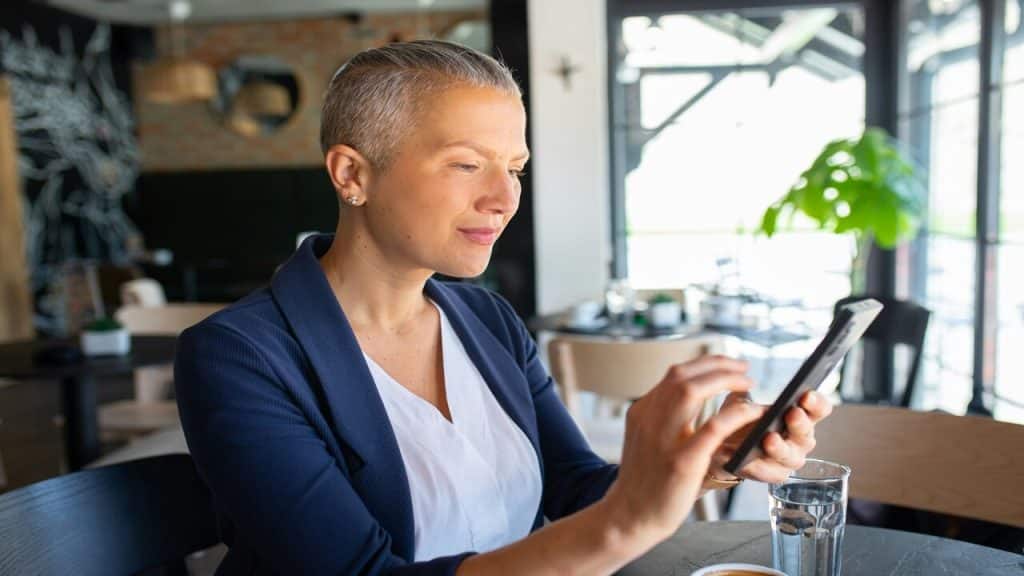 A mature woman looking sadly at her phone