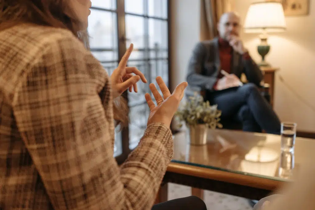 A man listening to a woman talking