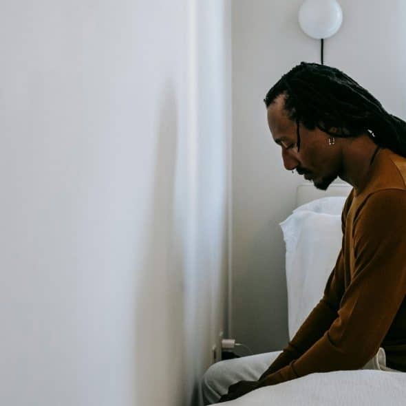 A man sitting at the bed