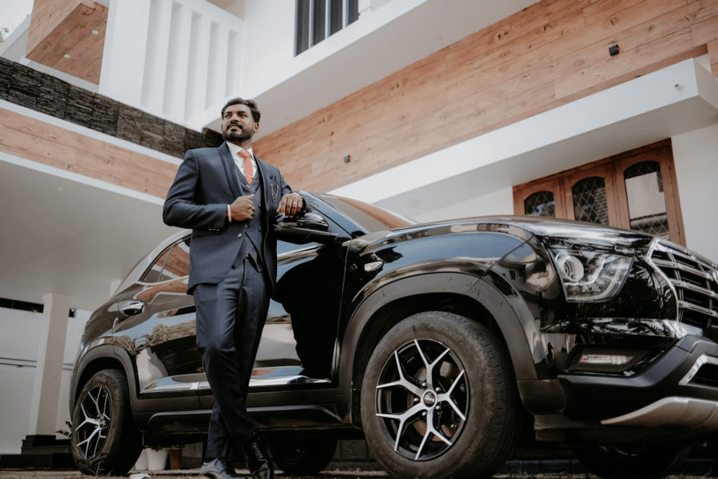 A man standing beside a car