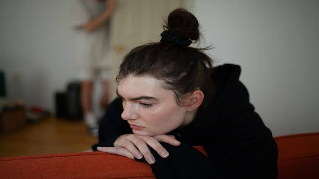 A woman looking sad at home