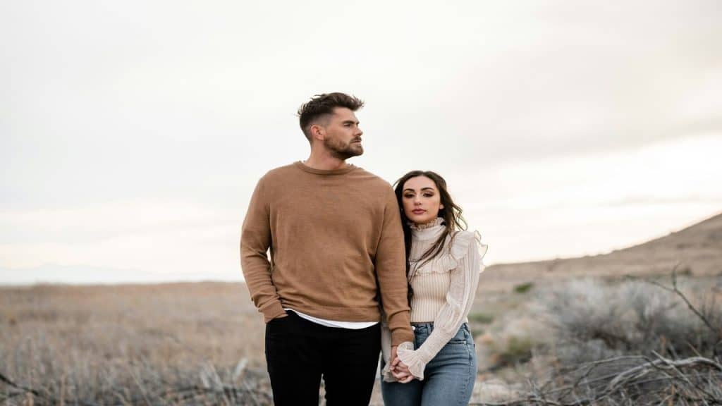 A couple looking serious while walking