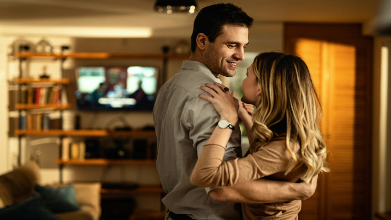 A couple dancing in the living room