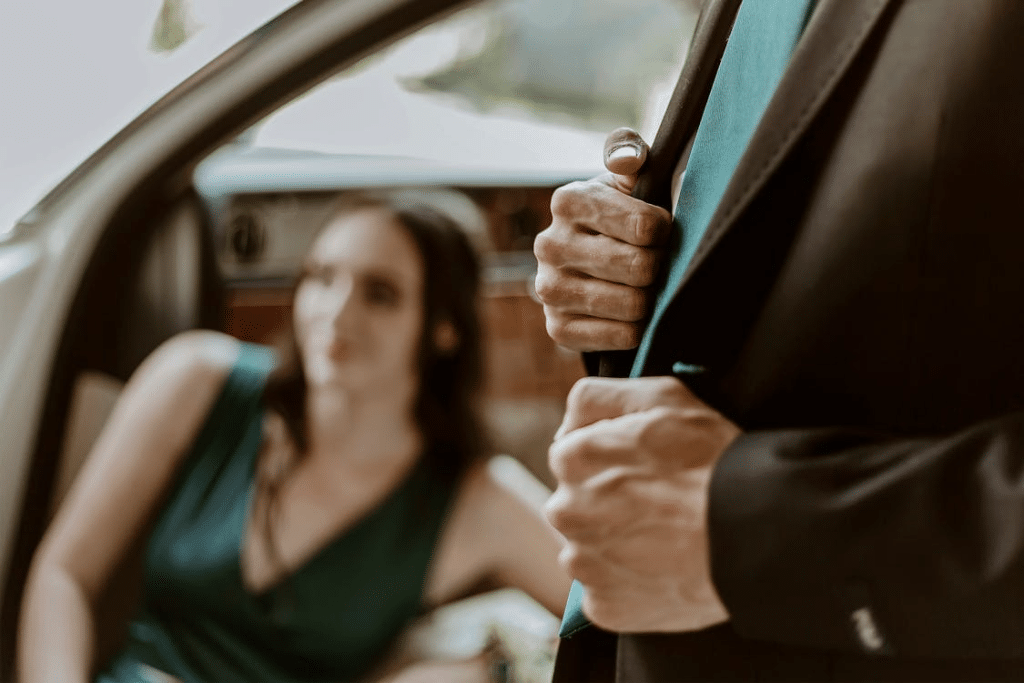 A man and a woman beside a car
