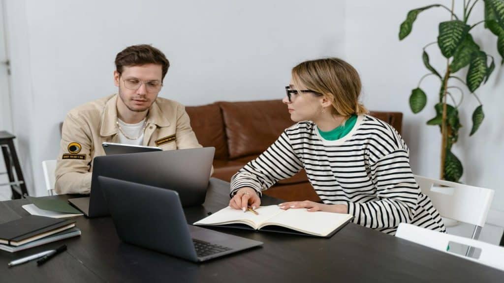 A couple looking at their laptops