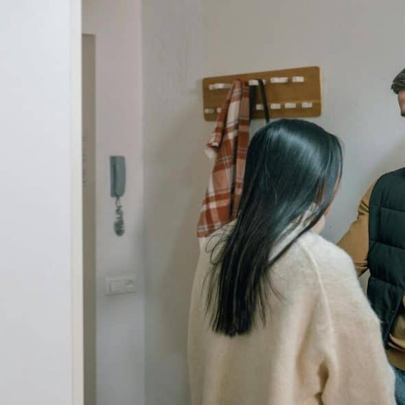 A couple having a serious talk by the entryway