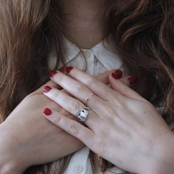A woman with her hands on her heart