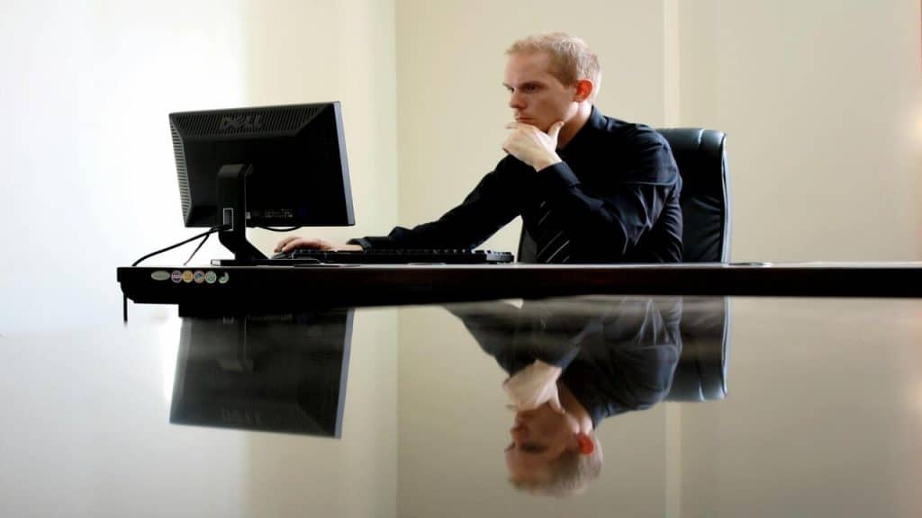 A man looking at his computer while at work