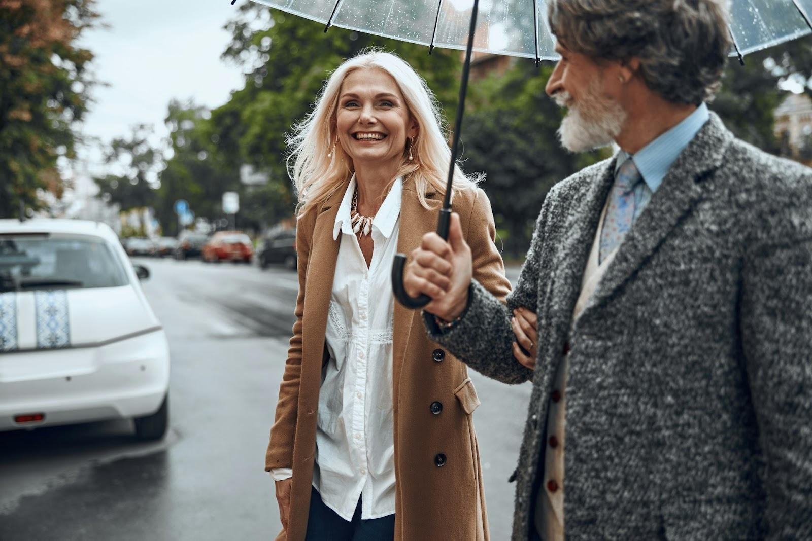 A mature couple crossing the street.