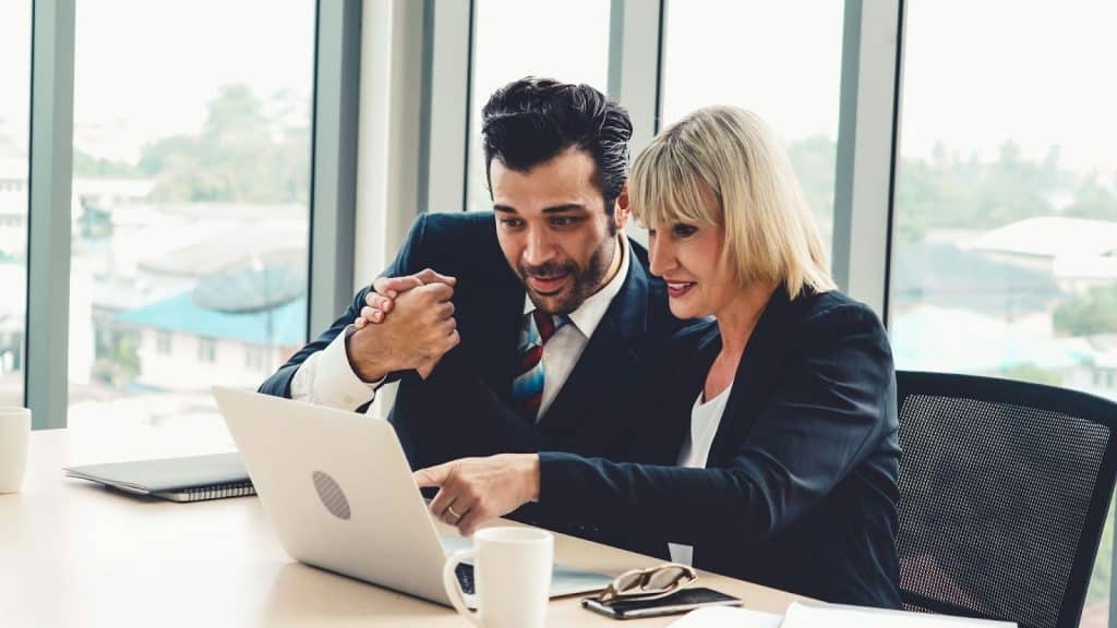 A man sharing something to coworker woman