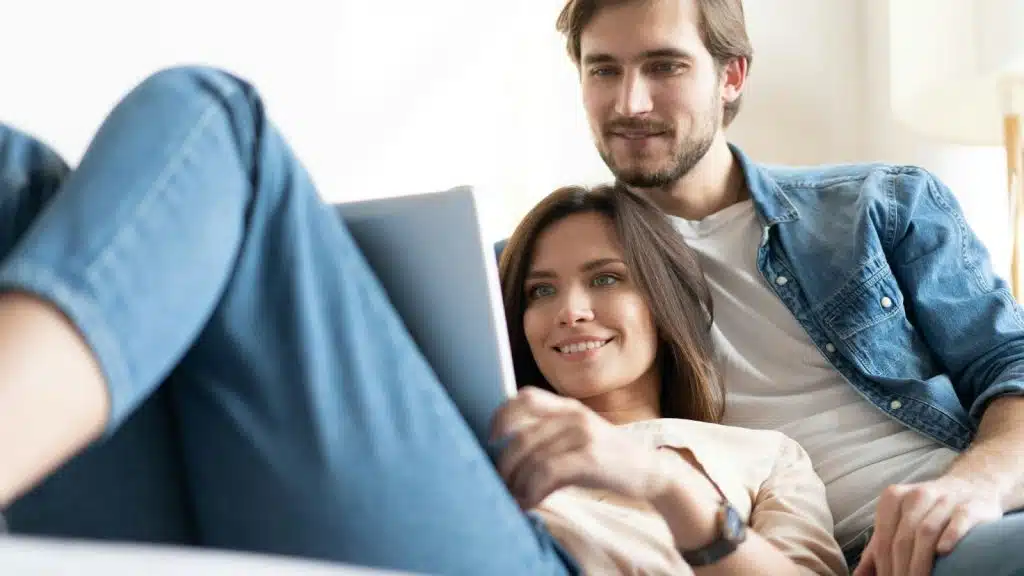 A man and woman looking at the tablet 
