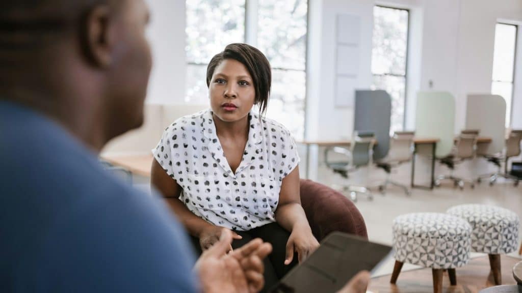 A man saying something to woman