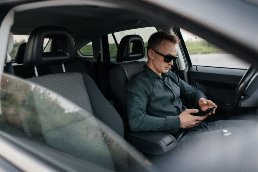 A man using his phone in a car