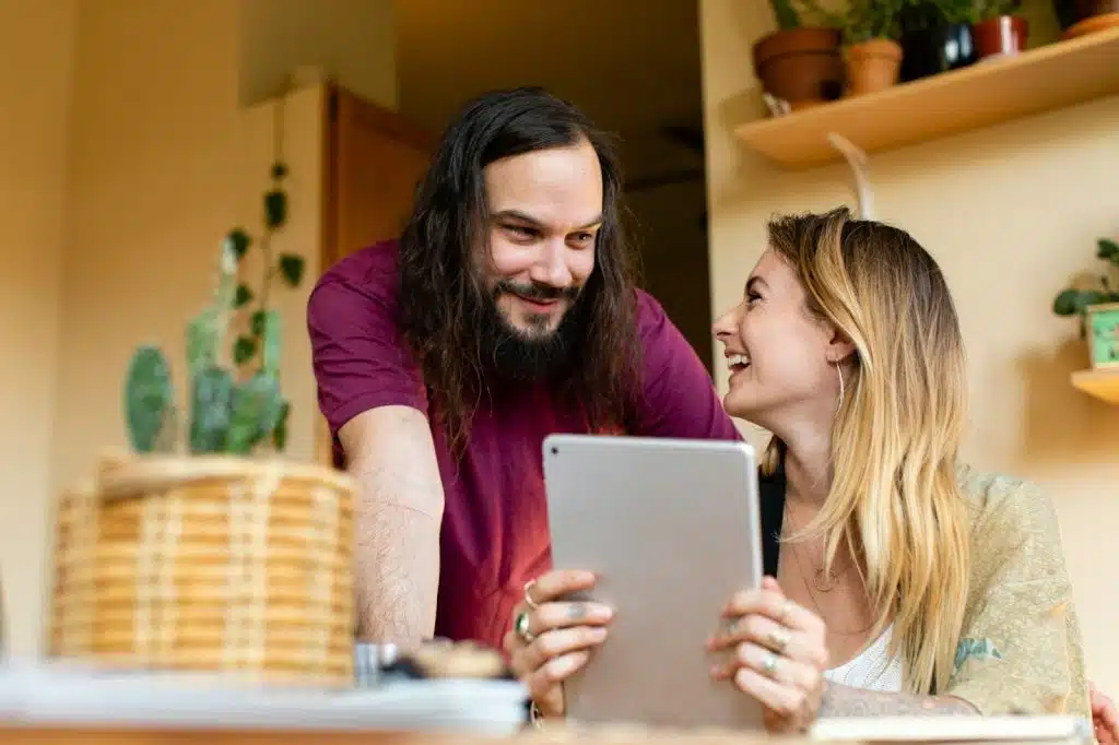 A man smiling at the woman
