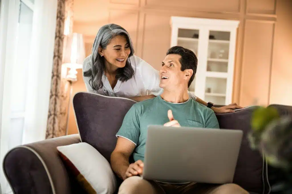A man busy working and a woman behind him