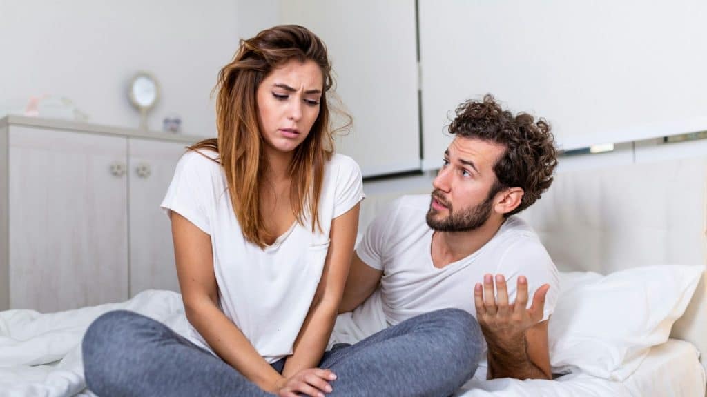 A man saying something to woman