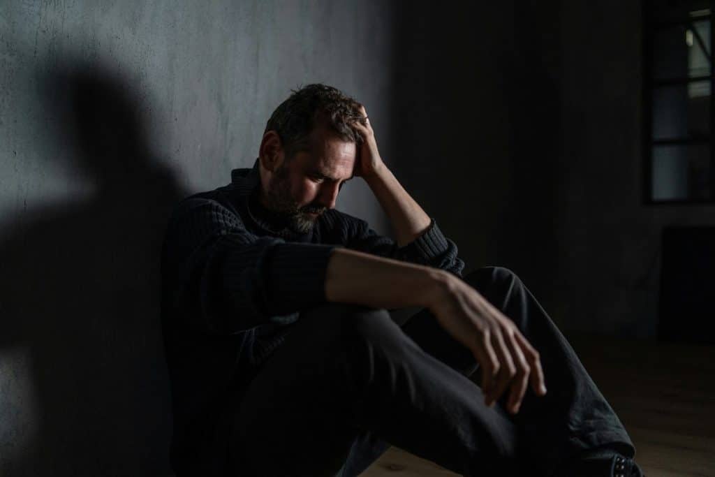 A sad man alone in the dark 
