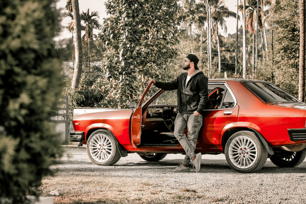 A man standing beside a car