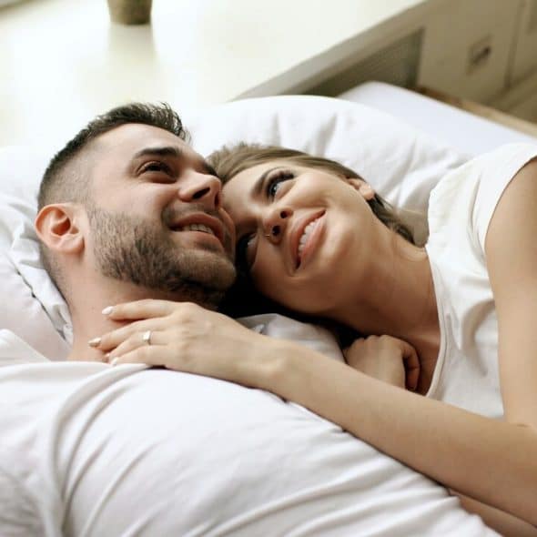 A couple cuddling at home together