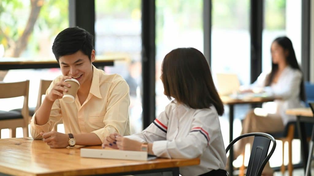 A young couple talking to each other.