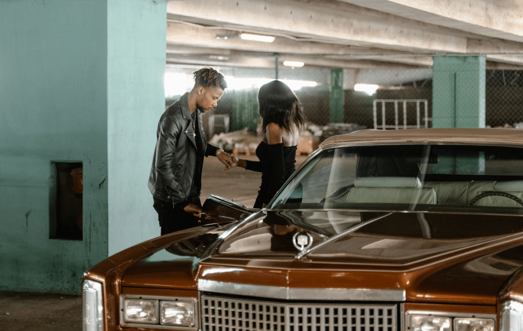 A man and a woman beside a car