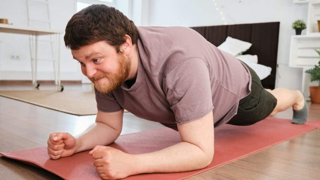 A bearded man doing plank exercise.