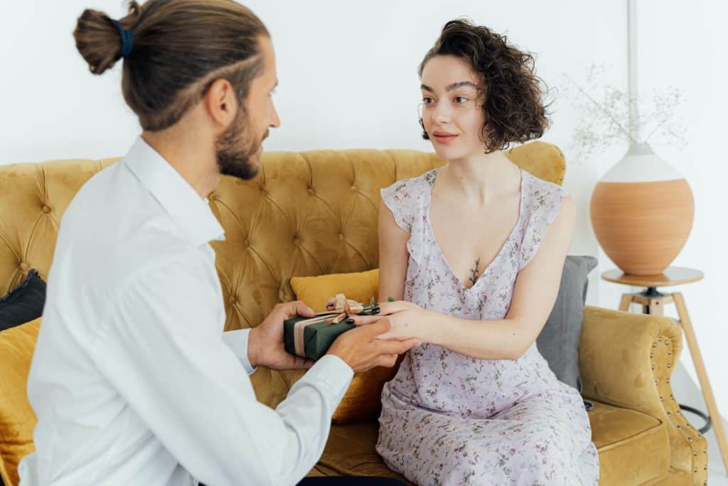 A man giving a woman a gift.