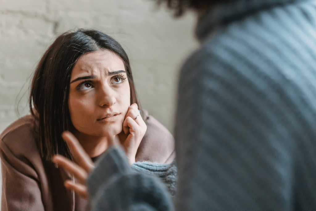 Sad woman looking at anonymous woman during conflict