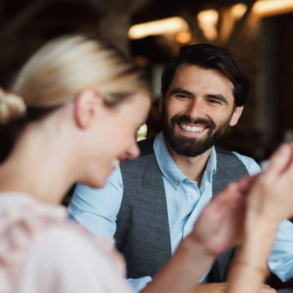 A couple laughing at a restaurant