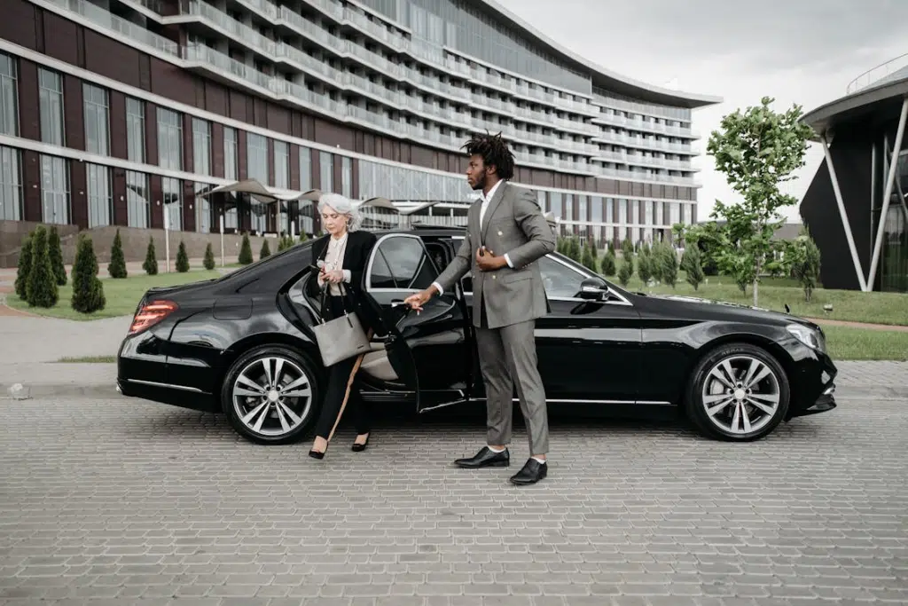 A man and a woman beside a car