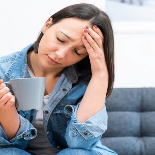 A woman looking tired and lonely at home