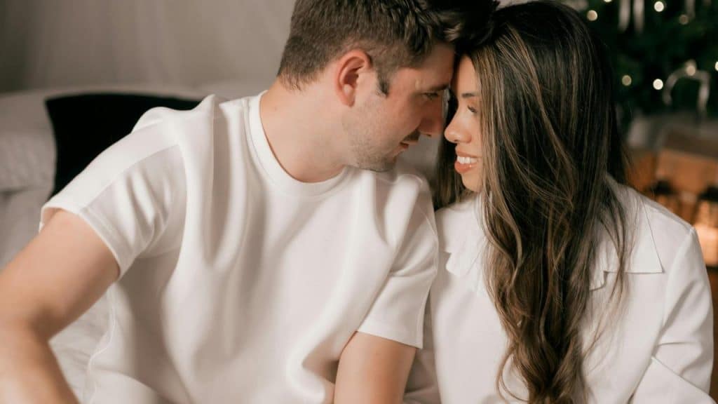 A couple leaning close together, sharing an intimate moment.