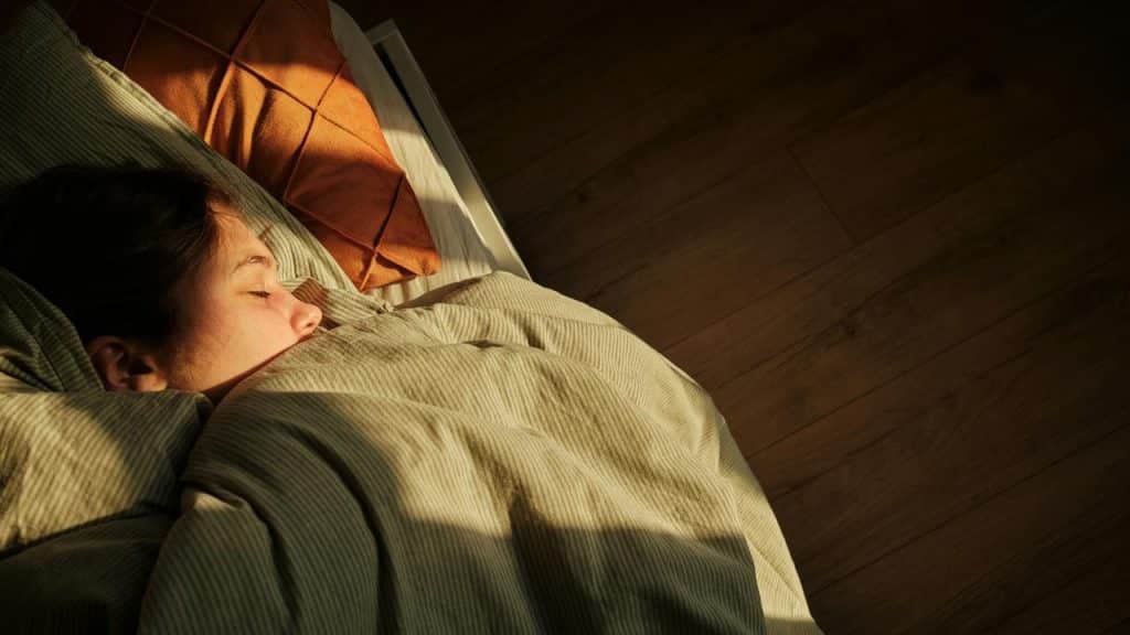 A person sleeping peacefully in bed