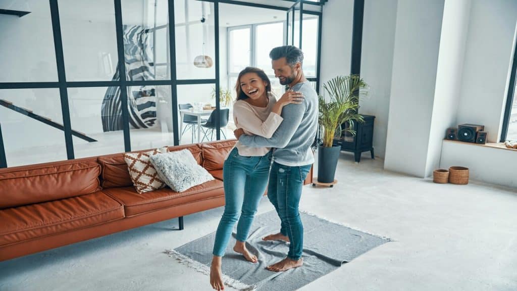 A couple hugging in the living room