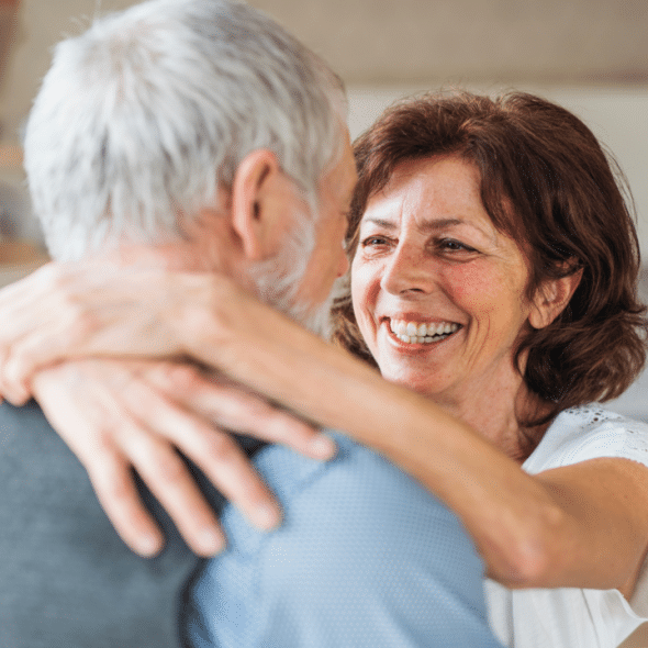 A mature couple hugging after a fight