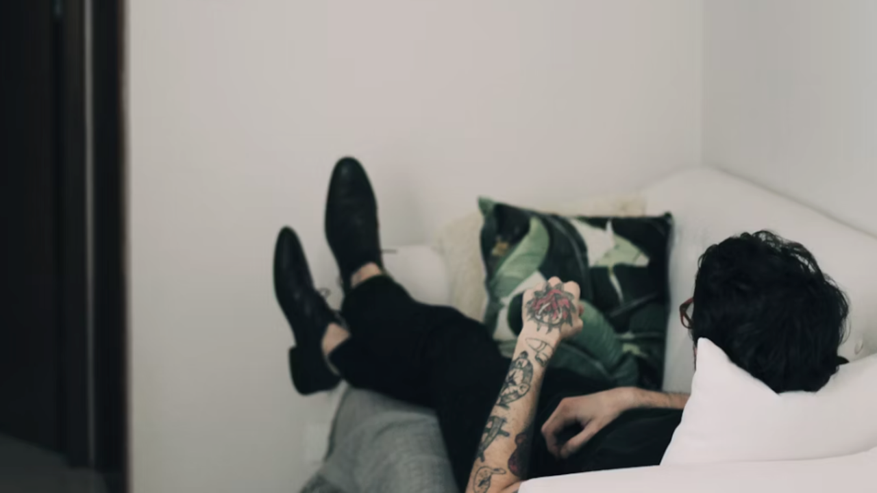 A man laying on the couch