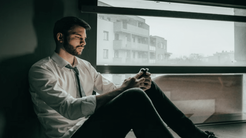 A man looking sad while texting